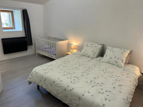 - une chambre avec un lit et un lit bébé dans l'établissement Maison d'Amie, à Ajoux