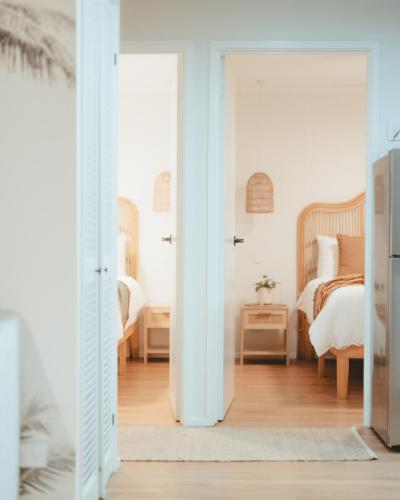 a room with a bedroom with a bed at Sanbis Cabin - hidden boutique retreat, sea views in Aldinga Beach