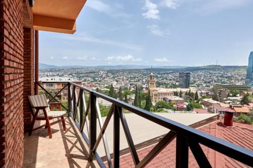 a balcony with a view of a city at GINGER Hotel in Tbilisi City