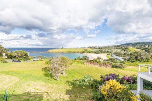 an ocean view from a house with a green field and a lake at Kiama Beach House & Private Beach & Newly Renovated in Kiama