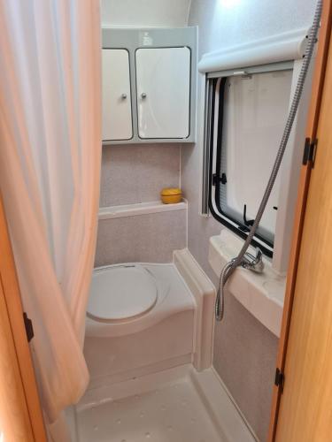 a small bathroom with a toilet and a mirror at Chałupy 3 VisitHel in Chałupy