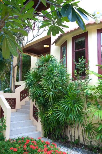 a house with stairs and plants in front of it at Samui Green Life in Bophut 