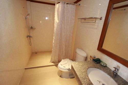 a bathroom with a toilet and a sink and a shower at Hua Hin Golf Villa in Hua Hin