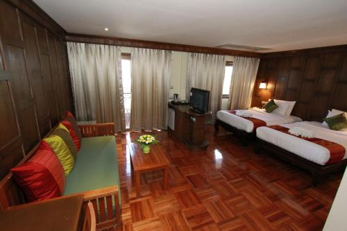 a hotel room with two beds and a television at Hua Hin Golf Villa in Hua Hin