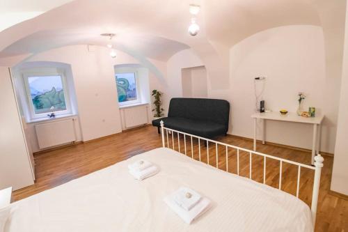 ein Schlafzimmer mit einem Bett und einem Stuhl in einem Zimmer in der Unterkunft Dragon's Cave in Ljubljana
