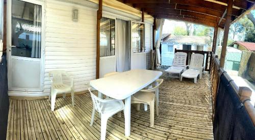 a porch with a table and chairs on a house at hakuna matata in La Ciotat