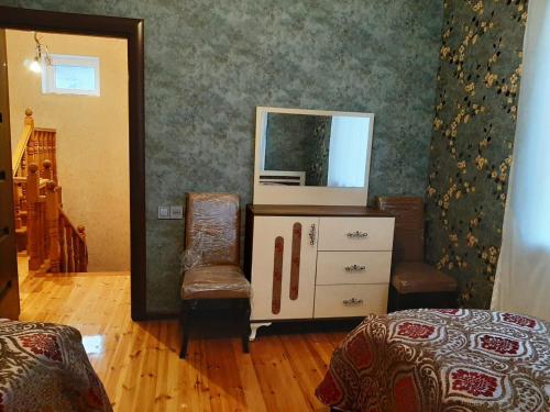 a room with a mirror and a dresser with a mirror at My sweet home in Ramana in Baku