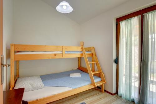 a bedroom with two bunk beds and a ladder at House Jasminka in Medulin