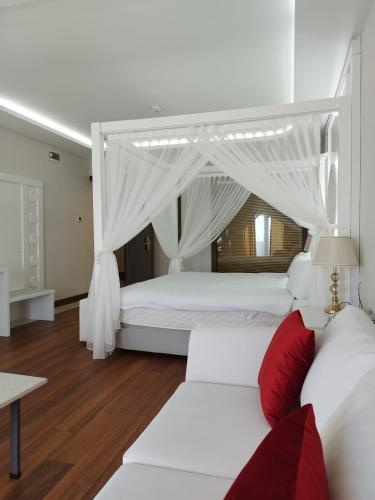a bedroom with two white beds with red pillows at The Sign Degirmen Hotel&Spa Wellness in Istanbul