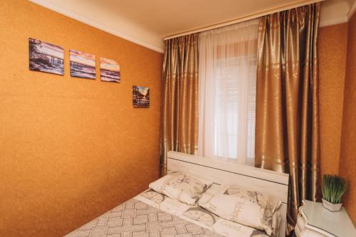 a small bedroom with a bed and a window at Квартира в центре города in Sumy