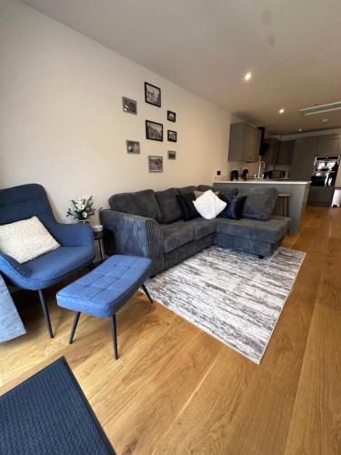 a living room with a couch and two chairs at House situated on River Itchen in Winchester