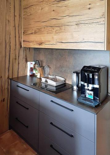 a kitchen with a counter with a coffee maker on it at Sklep Víno Strýček in Velké Bílovice