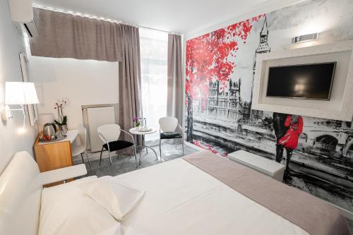 a hotel room with a bed and a tv on a wall at MyContinental Suceava in Suceava