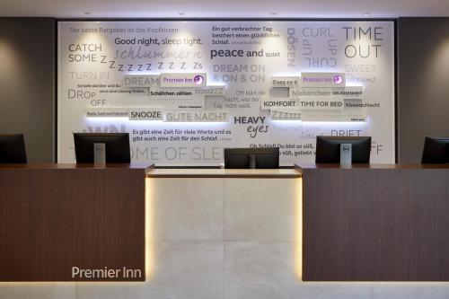 a wall with a large screen with words on it at Premier Inn Hamburg City Zentrum in Hamburg