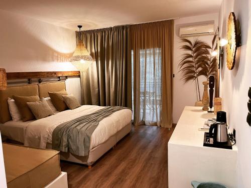 a bedroom with a bed and a large window at Evia Silence in Boufalo