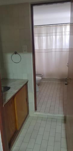 an empty bathroom with a toilet and a sink at Casa 3 habitaciones in General Alvear