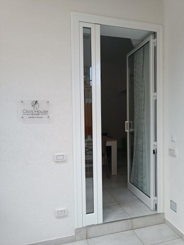 a sliding glass door leading into a room at Clio's House - Mondello in Mondello