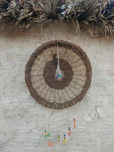 a basket with toys in it on a wall at Mbiama Resort in Siwa