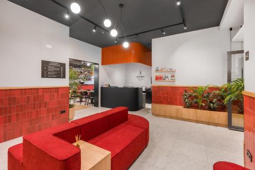 a waiting room with a red couch in a restaurant at Florin Apart Hotel in Budapest