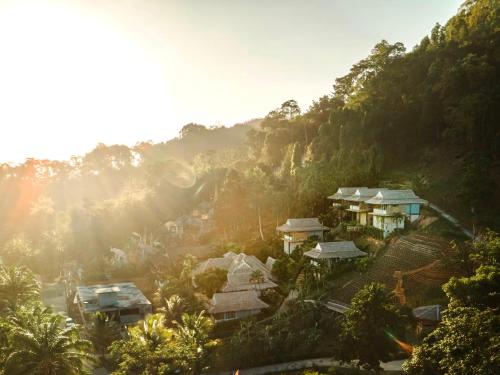 a view of a mountain with houses and trees at Baan Phuvara Retreat - Romantic Jacuzzi Mountain View Villas in Ao Nang Beach