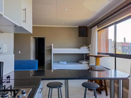 a kitchen with a bunk bed in a room at Ballito Bay Holiday Apartment in Ballito