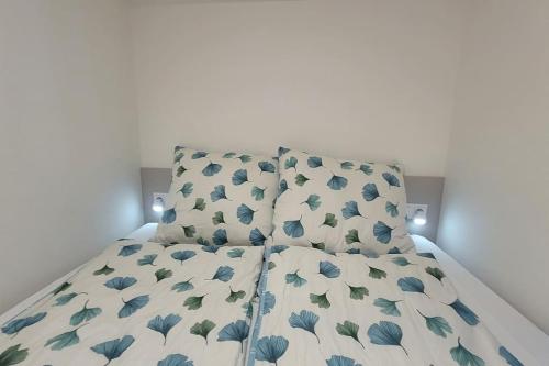 a bedroom with a bed with blue flowers on it at LOFT pri parku in Banská Bystrica