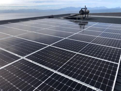 a group of solar panels on top of a roof at Penguinden - load-shedding free in Simonʼs Town