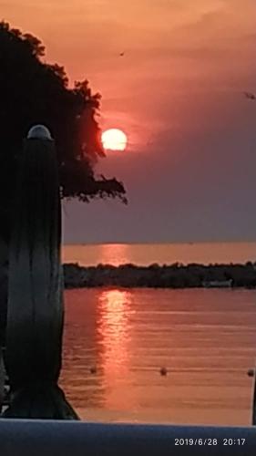 a sunset over a body of water with the sun at B&B Oasi Rooms in Agropoli