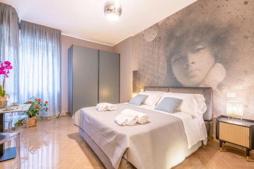 a bedroom with a bed with towels on it at City Gate - luxury suites in Bari