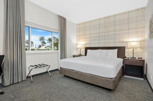a hotel room with a bed and a window at Ohio House Motel in Chicago
