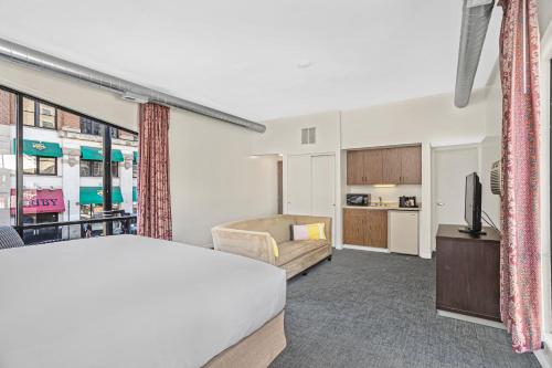 a hotel room with a bed and a living room at Ohio House Motel in Chicago