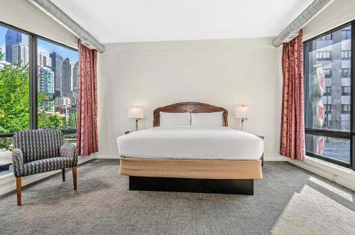 a bedroom with a bed and a large window at Ohio House Motel in Chicago