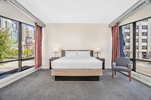 a bedroom with a bed and large windows at Ohio House Motel in Chicago