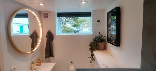 a bathroom with a sink and a mirror at The Kontor in Sandavágur