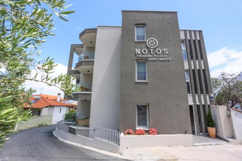 a building with the nocs sign on it at Notos Premium Holiday Apartments in Pefkohori