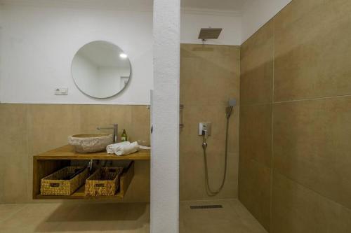 a bathroom with a shower with a sink and a mirror at Villa Zalin in Ovacik