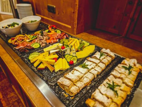 a platter of food on a table with sushi at Das Alpin - Hotel Garni Guesthouse in Scheffau am Wilden Kaiser