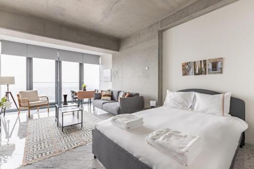 a bedroom with a large bed and a living room at Trendy Cool Bright Studio Parking Poolviews! #254 in Istanbul