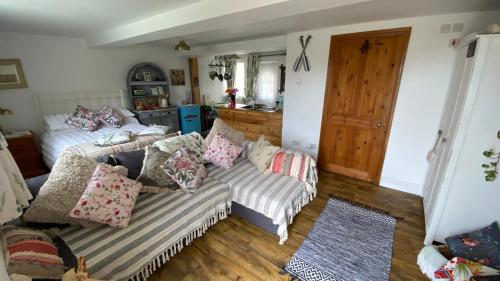 a living room with a couch and a bed at Wheelhouse - Grinkle Bell Cottage in Saltburn-by-the-Sea