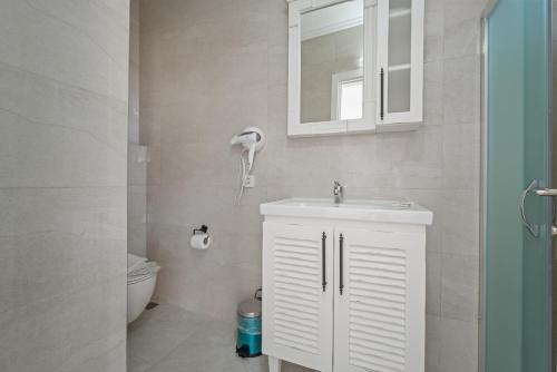 a bathroom with a white sink and a toilet at Blue Time Boutique Hotel in Marmaris