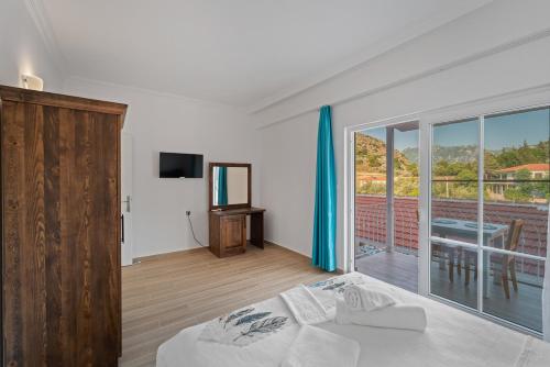 a bedroom with a bed and a balcony with a table at Blue Time Boutique Hotel in Marmaris