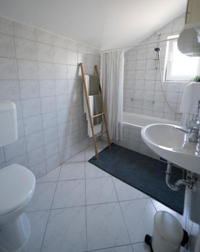 a bathroom with a toilet and a sink at L'infini Sea View apartments Zubovići in Zubovići
