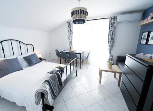 a bedroom with a large bed and a table at L'infini Sea View apartments Zubovići in Zubovići
