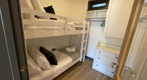 a small bedroom with bunk beds in a room at 3 chapel row cottages in Wirksworth