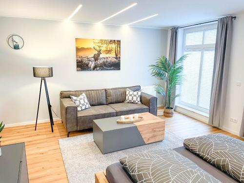 a living room with a couch and a table at Appartement am Mythenweg in Thale