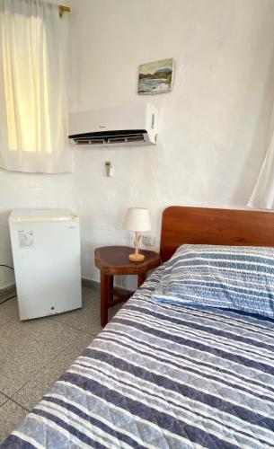 Postel nebo postele na pokoji v ubytování Hostal Galapagos by Bar de Beto