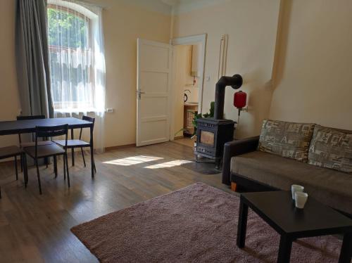 a living room with a couch and a wood stove at St.Pauls apartment in Riga