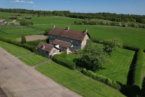an aerial view of a large house in a field at Cliff Stud Retreat - Luxury lodges and cosy cottages in Helmsley