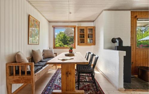 a dining room with a table and a couch at 2 Bedroom Nice Home In Jægerspris in Jægerspris
