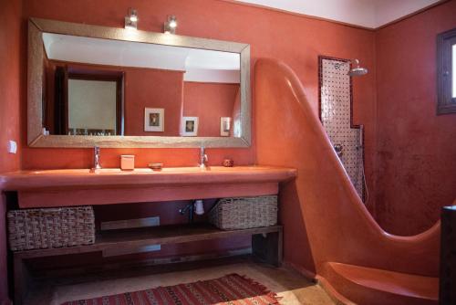 a bathroom with a sink and a mirror at Jnane Allia in Douar Soukkane